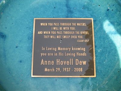 A plaque in the bottom of the bird bath in the garden.